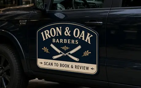 Sample truck door magnet for the fictional Iron & Oak Barbers reading Scan to book and review